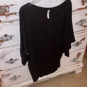 Women’s black blouse with “bat sleeves”.